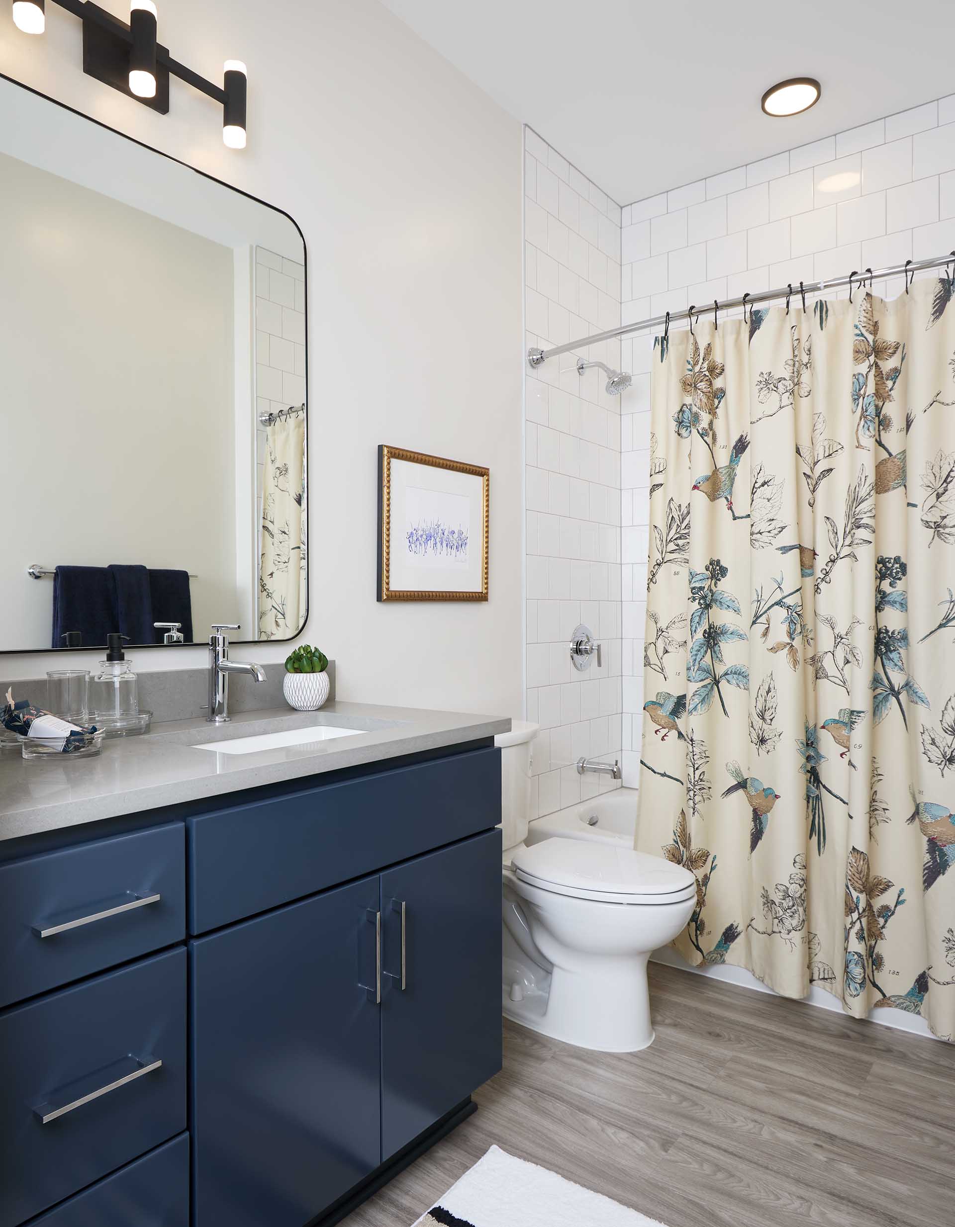Spacious bathrooms with ample cabinetry and quartz countertops